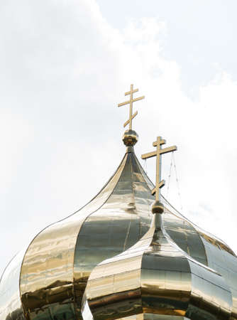 The Golden Church Dome of the Orthodox Church over sky with cloudsの写真素材