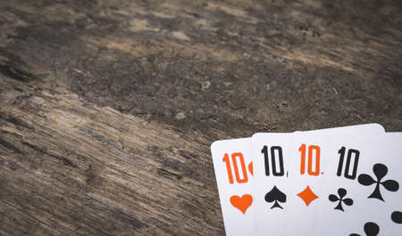 Playing cards four ten with copy space on the wooden table game abstractの写真素材