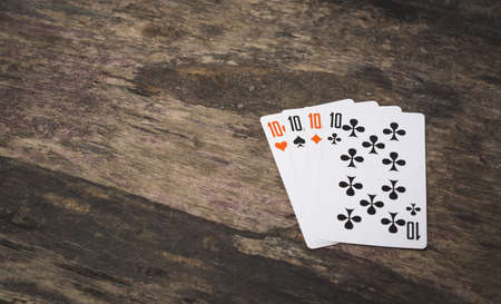 Playing cards four ten with copy space on the wooden table game abstractの写真素材
