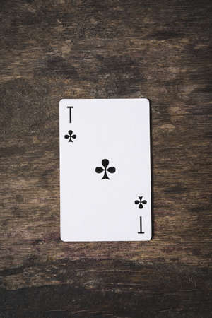 Ace of clubs playing cards on the wooden tableの写真素材