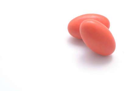 two red pills isolated on white background with copyspaceの写真素材