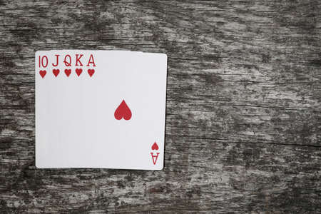poker hand: royal flush. playing cards game abstract in wooden tableの写真素材
