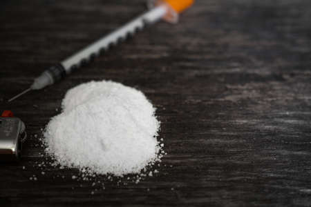 the heroin with syringe on the table