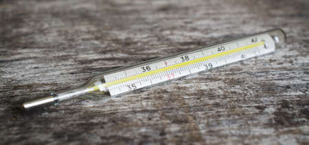 mercury thermometer on wooden tableの写真素材