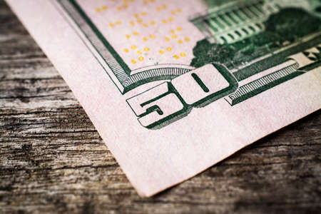 Close up of 50 Dollar bill on wooden tableの写真素材