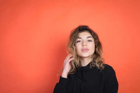 portrait of a beautiful girl over red background with copyspace