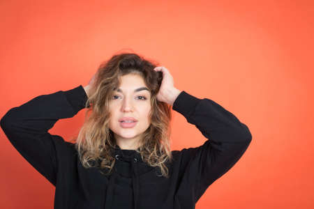 glamour portrait of a beautiful girl on a red background