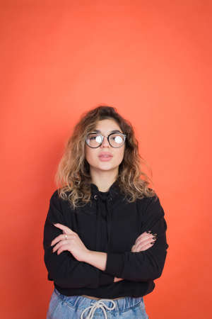 portrait of beautiful stylish girl on red backgroundの写真素材