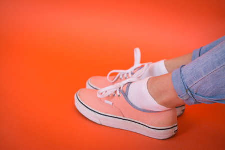 Young Fashion Woman legs over red background