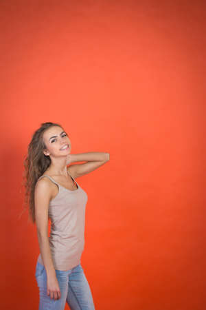 cute girl portrait on red background with copyspaceの写真素材