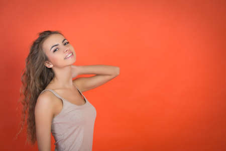 cute girl portrait on red background with copyspaceの写真素材