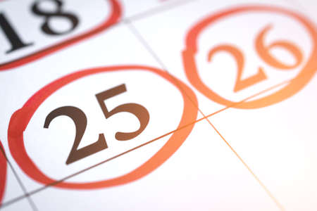 Red circle marked with pen on a calendar sheet twenty fifth dateの写真素材