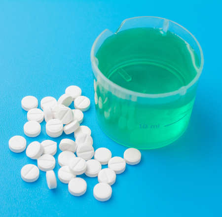 flu medicine closeup, medical abstract, blue background