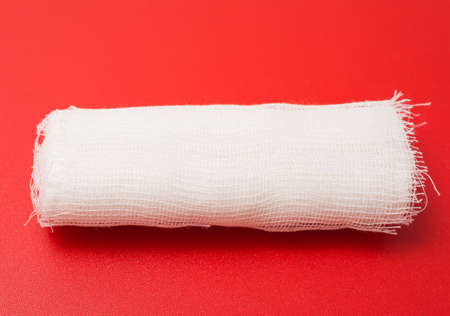 medical bandage roll red backgroundの写真素材