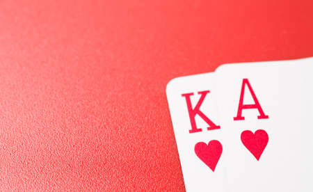 Poker hands playing cards king and ace on a red background
