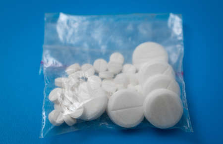 pills drugs pack on a blue background