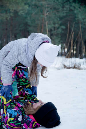 Mother and child girl on a winter walk having funの写真素材