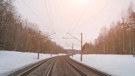 Train tracks in winter mist landscape, forest snowの写真素材
