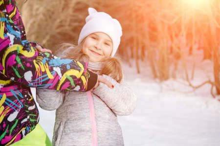 portrait of a beautiful little girl in winter park lifestyle dressの写真素材