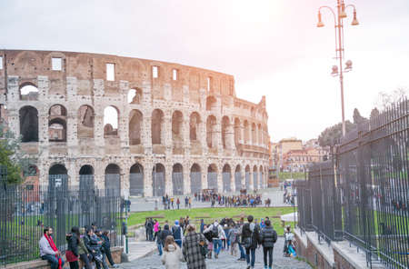 Rome, Italy - February 23, 2019: Rome cityscape colosseum view with tourist on sidewalk
