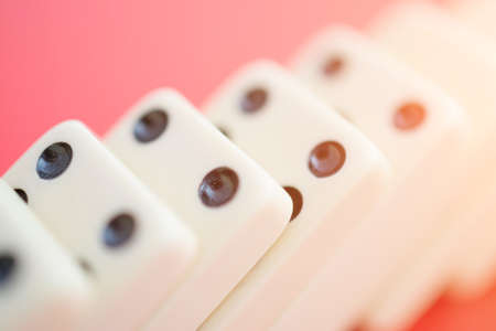 Dominoes on red table isolated, symbol abstract