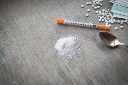Wooden table with drugs tools, addiction abstractの写真素材
