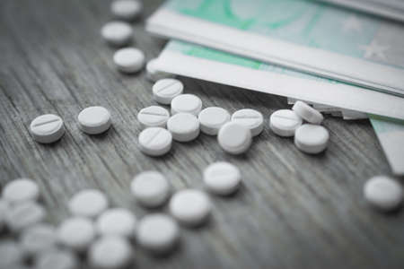 Painkiller on wooden table close upの写真素材