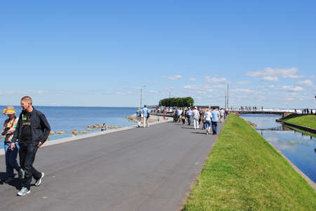 PETERHOF, RUSSIA -JULY 01, 2011: Peterhof scenic view of Neva harbor, side walk with people.のeditorial素材