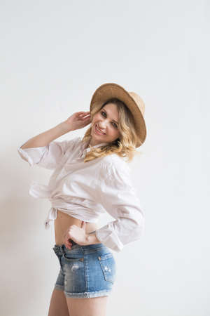 Sexy girl on a white background in a village hatの写真素材