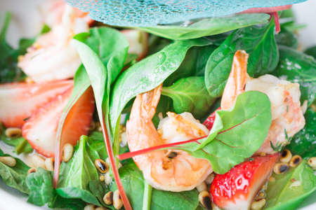 Closeup photo of salad with tiger prawns and strawberriesの写真素材
