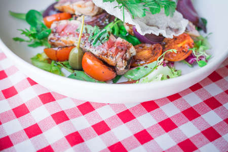 healthy food background or texture, fresh tasty vegetable salad with red fish, tomatoes, balsamic spicyの写真素材