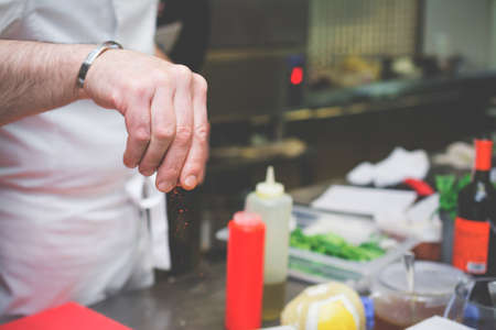 Hand sprinkling cayenne pepperの写真素材