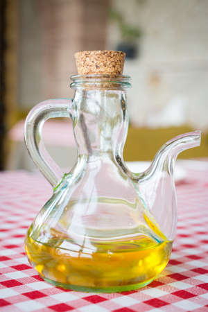 a glass bottle of olive oil tableの写真素材