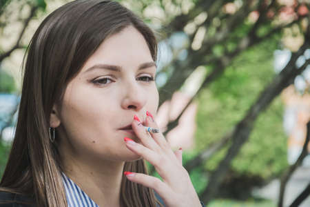 Girl smoking outdoors