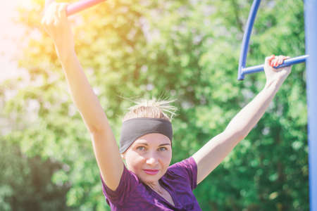 Portrait of a beautiful girl athlete who plays sports in nature