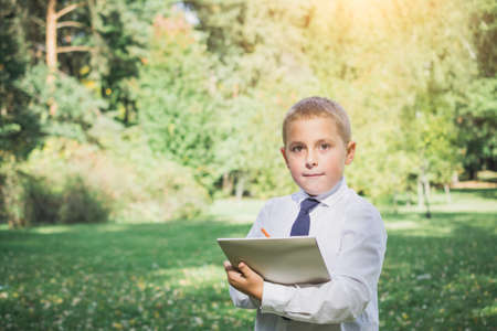 The boy writing book with pencil in the park, education conceptの写真素材