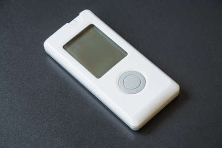 Blood sugar meter for diabetics close-up on black backgroundの写真素材