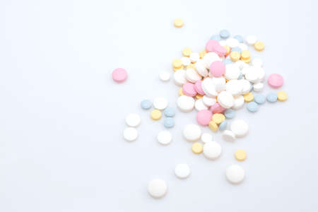 coronavirus treatment with pills concept, slide of colored pills on white backgroundの写真素材