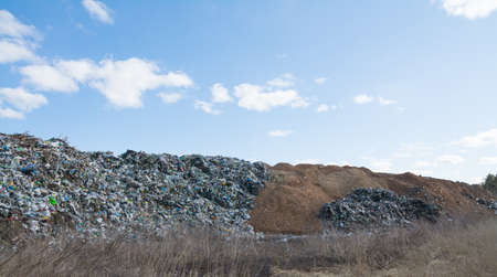The mountain of plastic waste from urban communities and industrial districts and the blue sky landscapeの写真素材