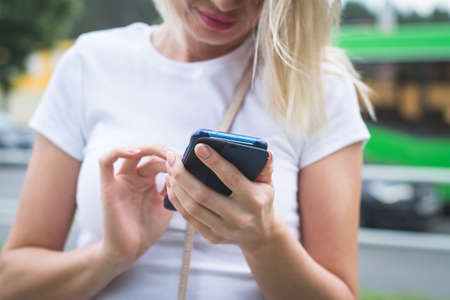 Close up photo of female hands touching screen smartphone outdoor, copyspaceの写真素材