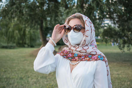 elegant girl in protective mask portrait outdoor