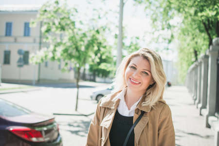 Stylish young blonde woman portrait in summer park