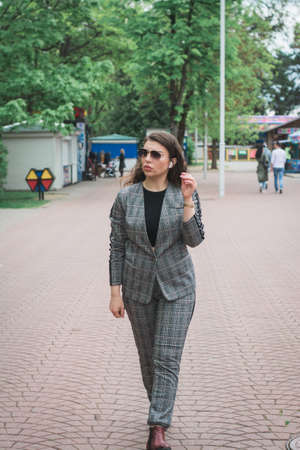Fashionable young woman relaxing on a summer day in the cityの写真素材