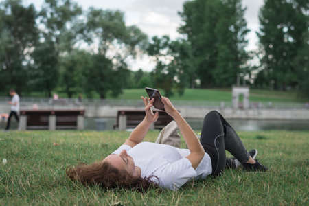 Girl and cell phone close-up shot on a summer dayの写真素材