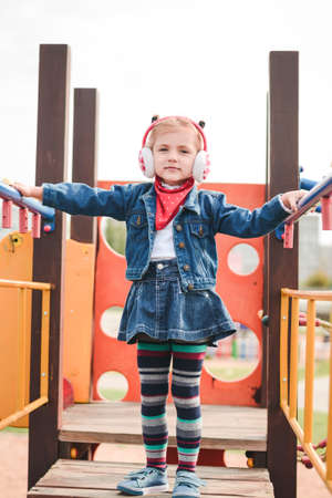 beautiful little girl playing in the playground outdoor