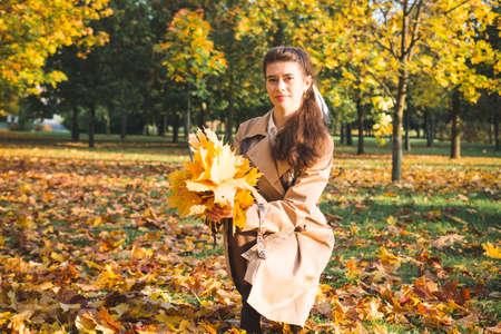 Stylish girl model is photographed in autumn parkの写真素材