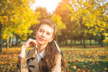 Stylish girl model is photographed in autumn parkの写真素材