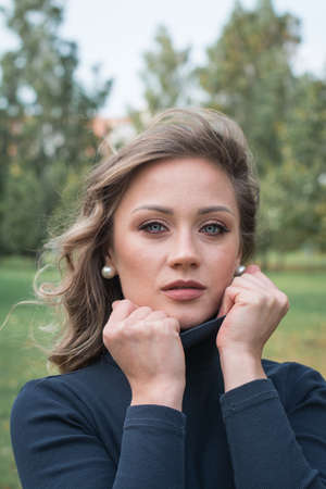 Portrait of a glamorous girl close up in a city park