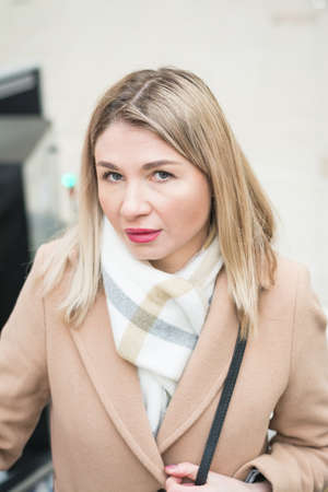 Beautiful business woman in a business suit is photographed in the business center