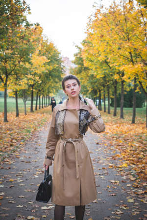 Happy Lifestyle portrait of a beautiful young model girl in city parkの写真素材